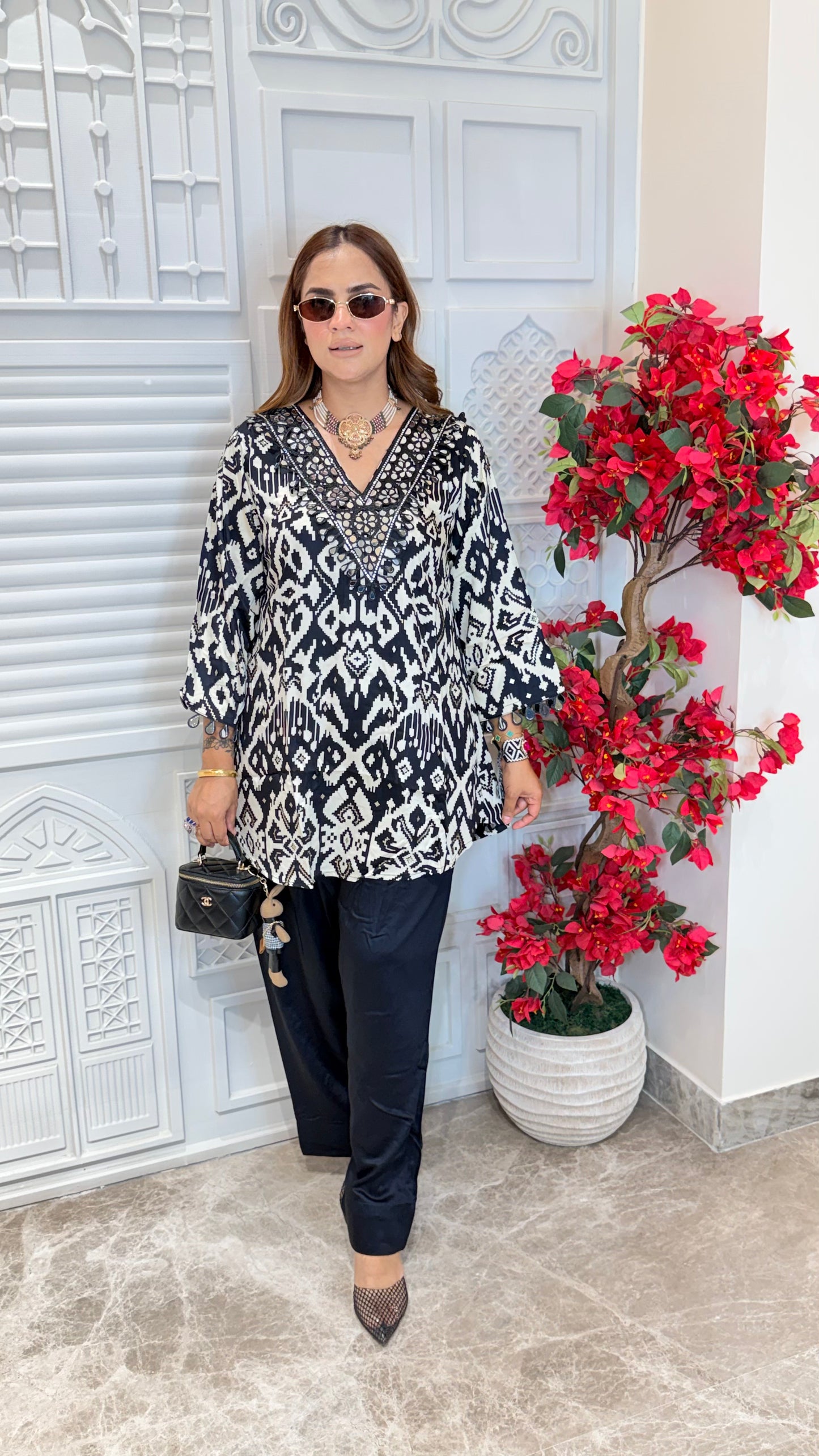 Elegant V-neck tunic paired with relaxed black trousers PC3478