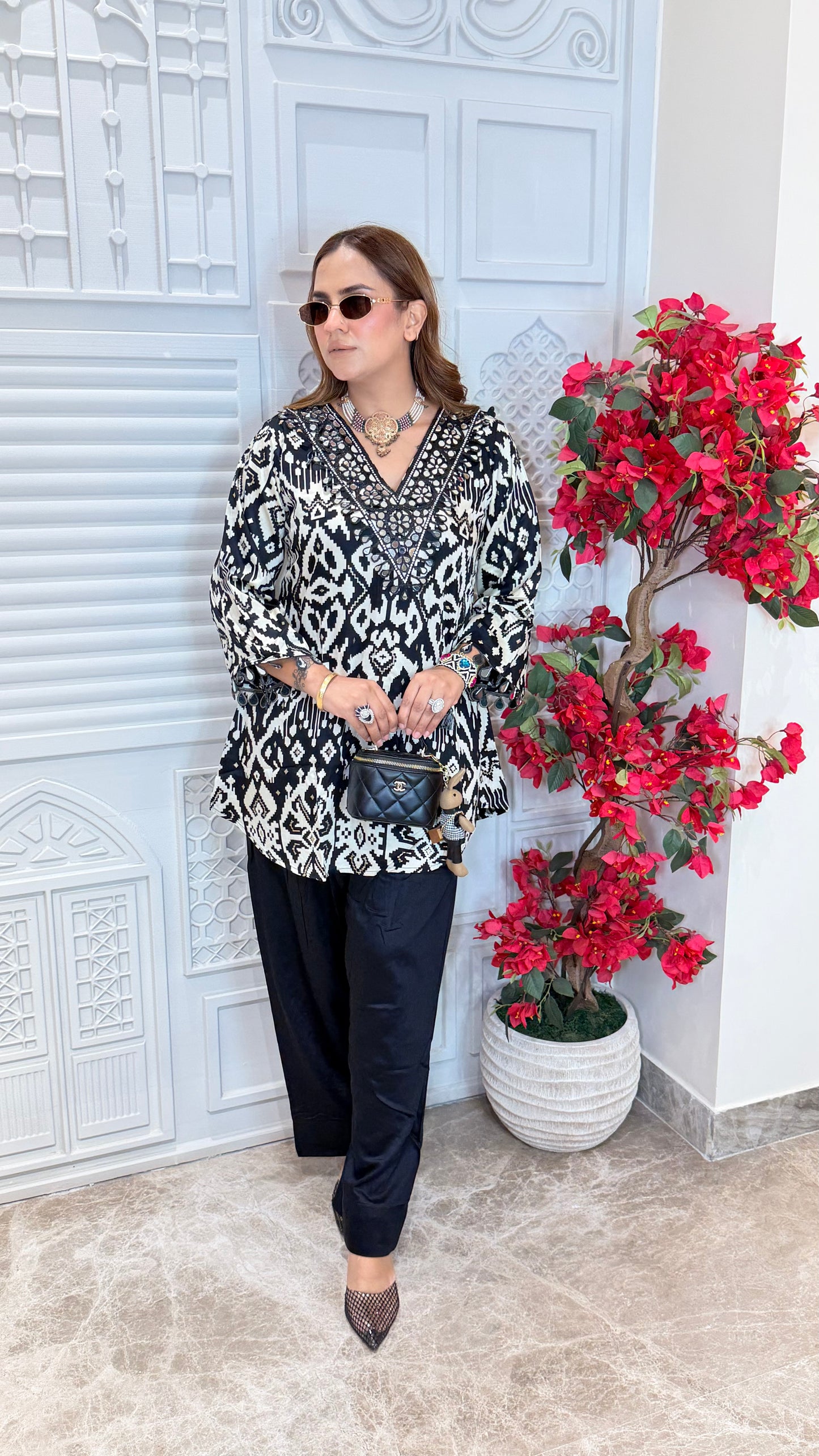 Elegant V-neck tunic paired with relaxed black trousers PC3478