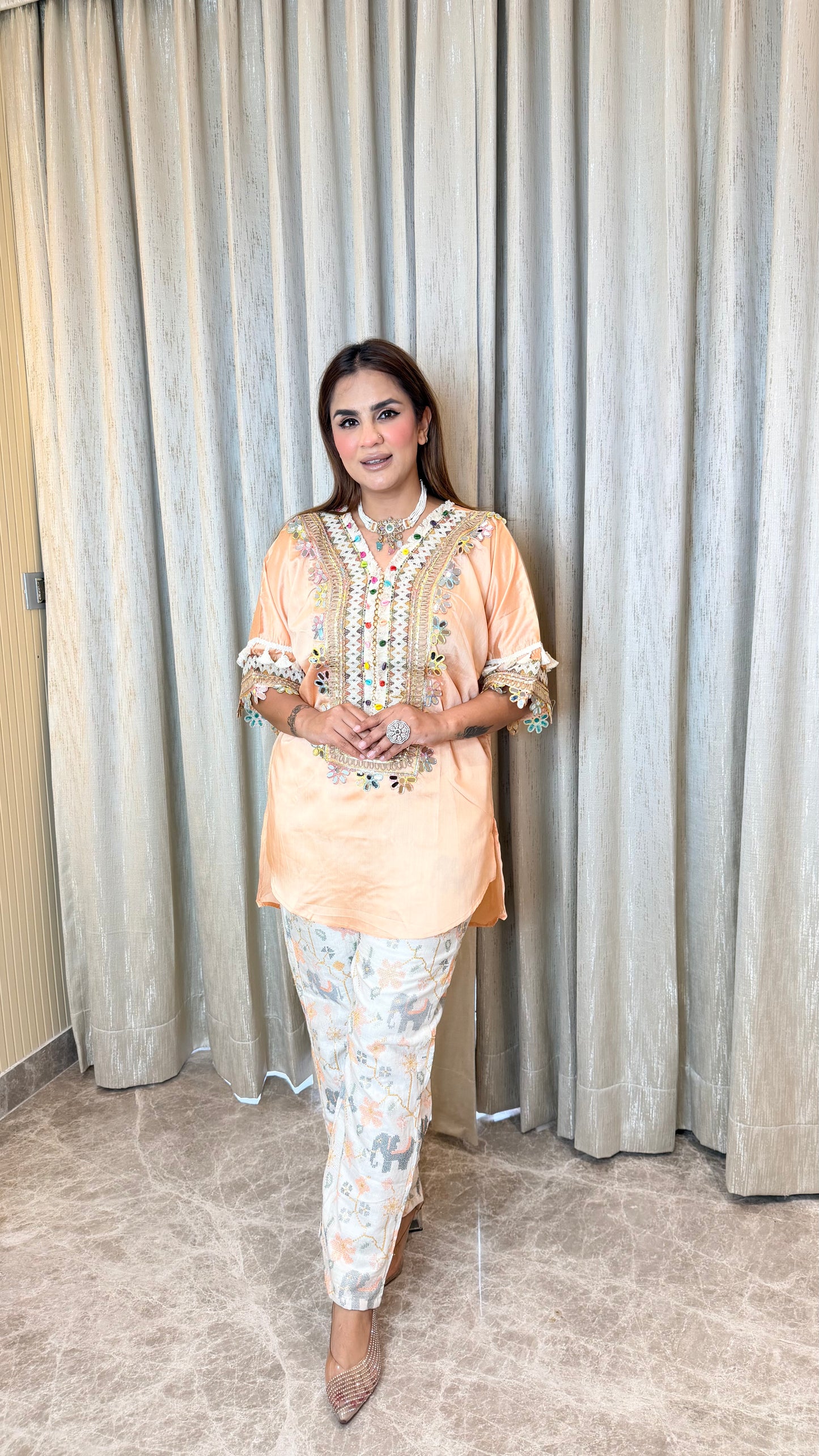 Elegant peach-colored embroidered tunic paired with patterned printed trousers pc3595