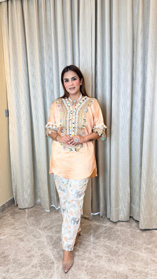 Elegant peach-colored embroidered tunic paired with patterned printed trousers pc3595